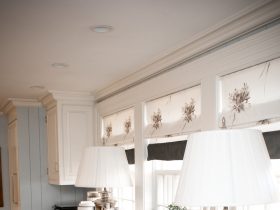 custom made flat roman shade window treatment over the kitchen sink