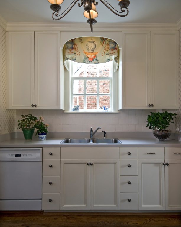 custom made window treatment with a classic print over the kitchen sink