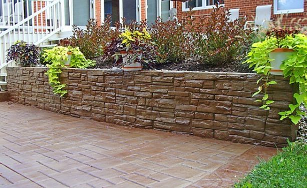 dark tan and stone pattern stamped concrete retaining wall