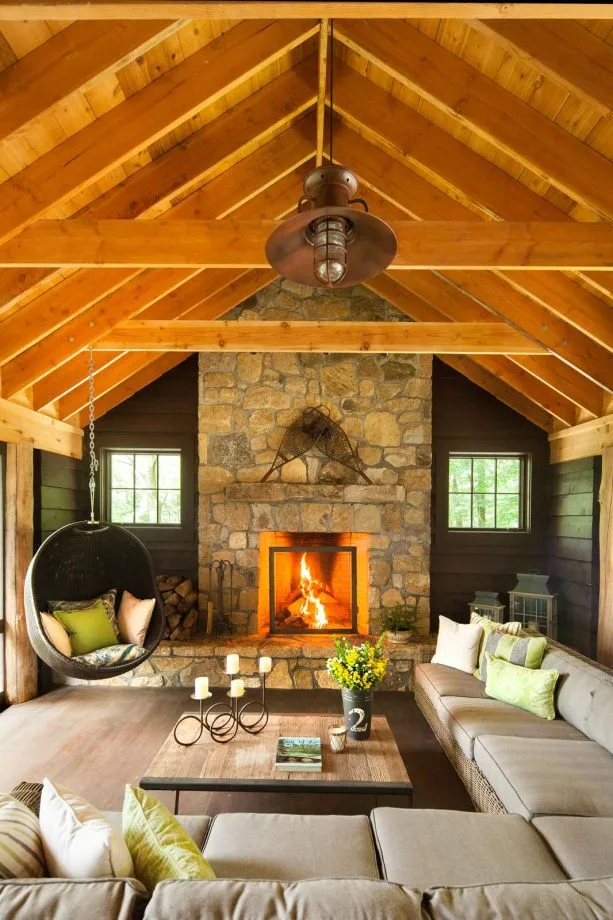 enclosed cabin living room with black painted cedar walls
