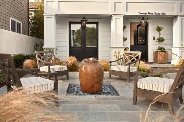 front yard patio in a lovely beach style with a decorative fountain