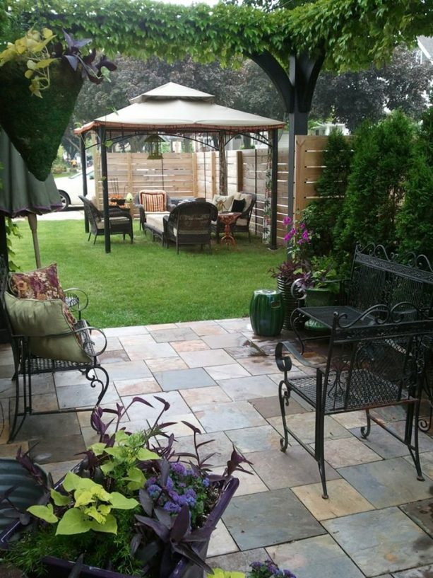 mediterranean style front yard patio with tile in mid-size