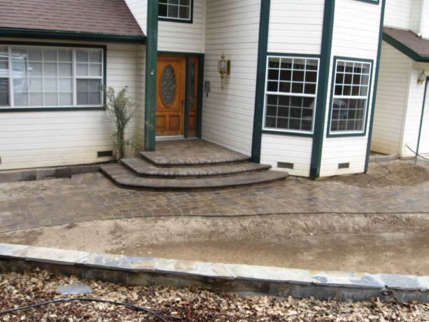 mountain style concrete paver steps against a house on the front porch