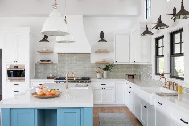 rustic black wall mounted light over an undermount rinse sink