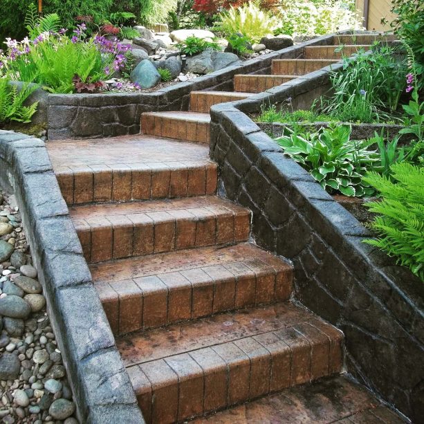 rustic staircase completed with stamped concrete retaining walls in both sides