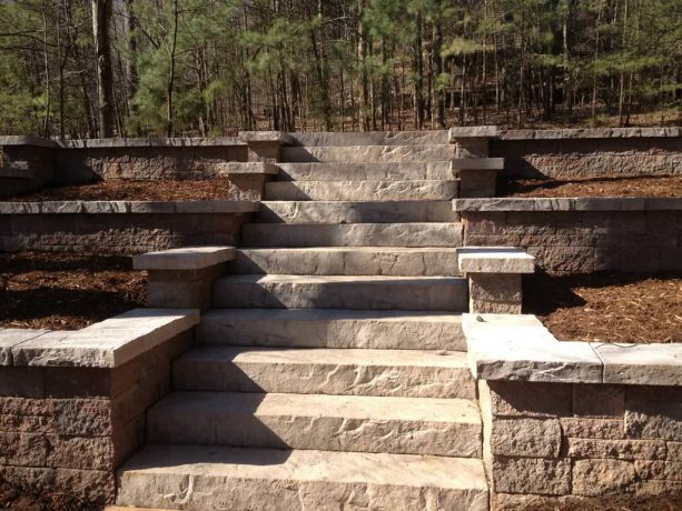 terraced stamped concrete retaining walls with a staircase in the center