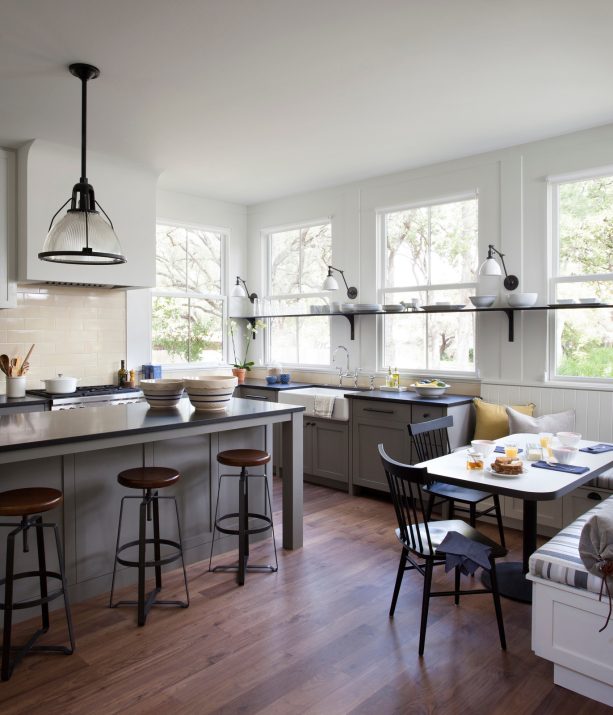 three customized wall mounted lights over a kitchen sink