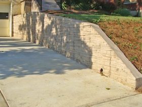 timeless textured stamped concrete retaining wall in a traditional landscape