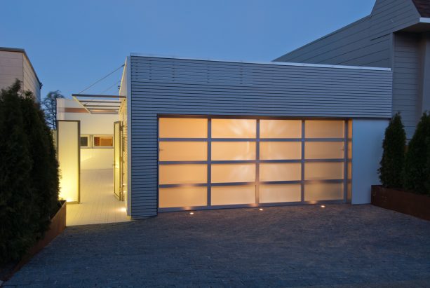 using metal fabricator and glass for a flat panel garage door combined with metal siding