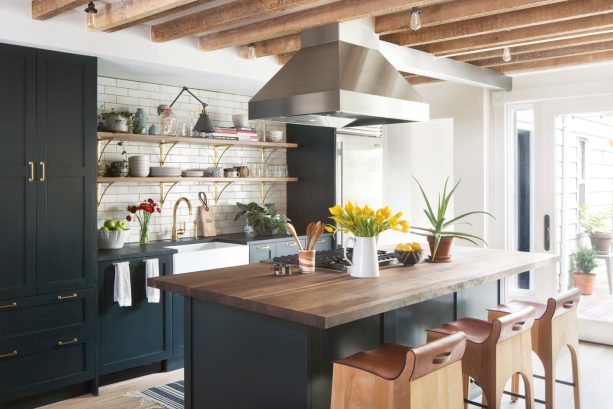 wall-mounted matte black light over a kitchen sink