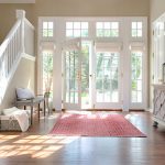 white roman shades for white french doors and windows in an entryway