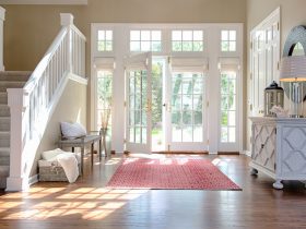 white roman shades for white french doors and windows in an entryway