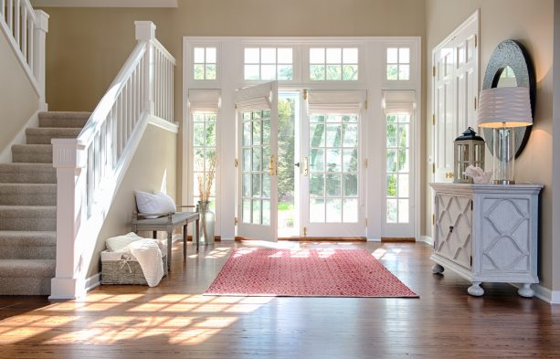 white roman shades for white french doors and windows in an entryway