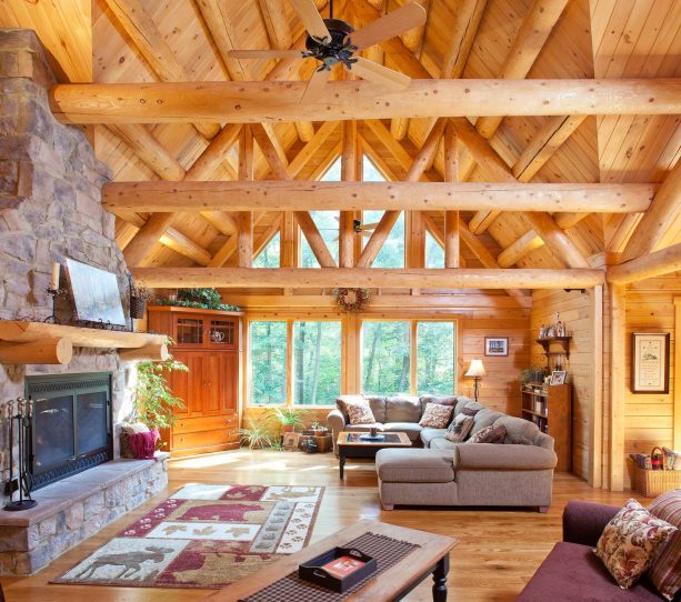wood walls ceiling and floor combined with stone fireplace in a cabin living room