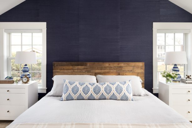 a contrasting look of white windows on a navy wall in a modern farmhouse bedroom