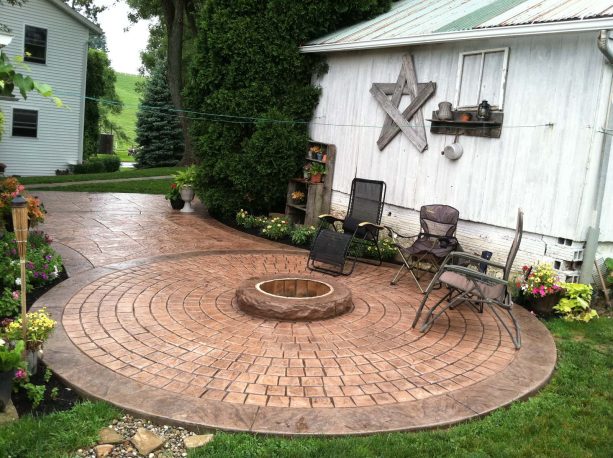 cappuccino and terracotta color combination stamped concrete patio with fire ring