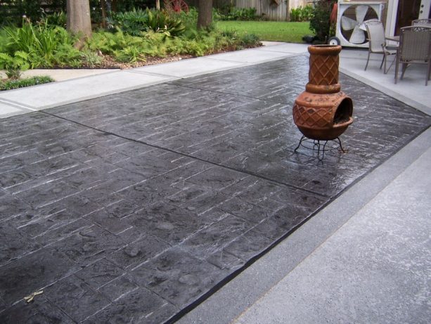 combination of charcoal gray color stamped concrete with a light colored stone