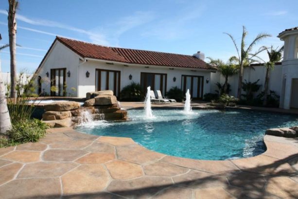 combination of several shades of brown stamped concrete color in a traditional style pool