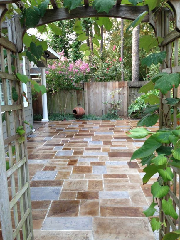 combination of tans, grays, and browns in a stamped concrete backyard