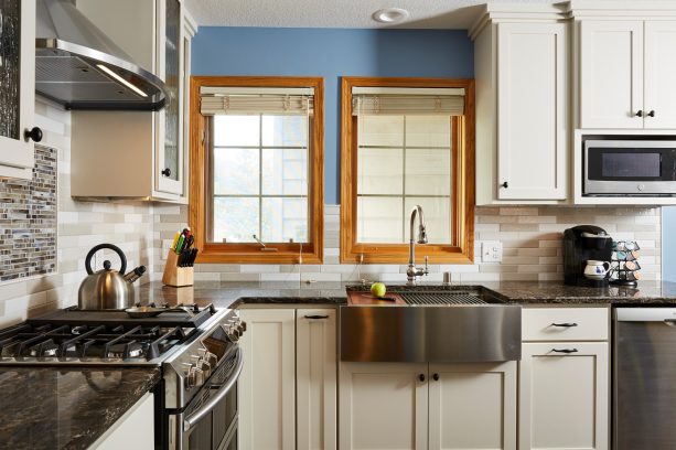 contemporary kitchen with bright blue wall paint color and honey oak trim