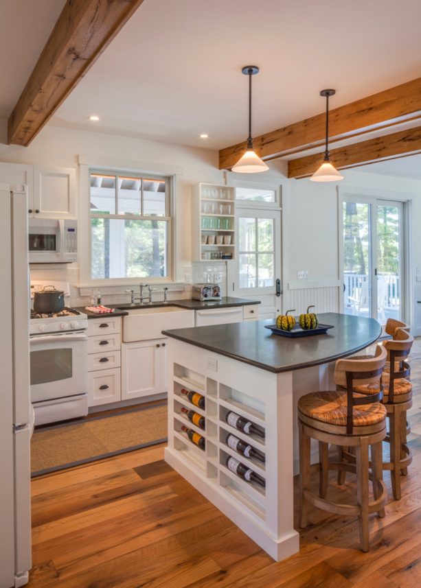 curved island with a dark countertop in a small country l-shaped kitchen