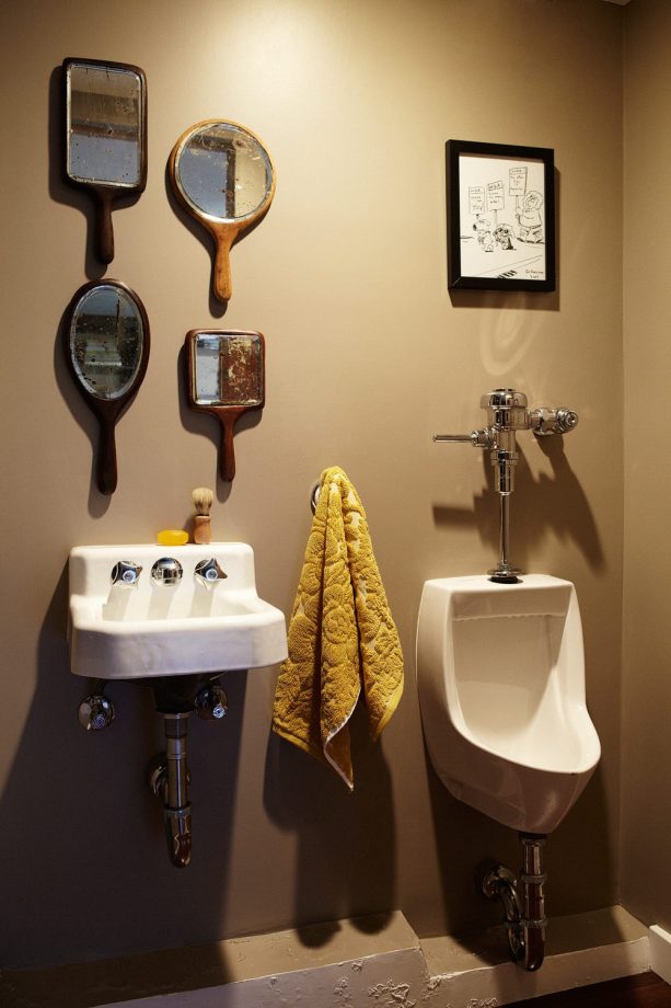 eclectic man cave bathroom idea with a urinal