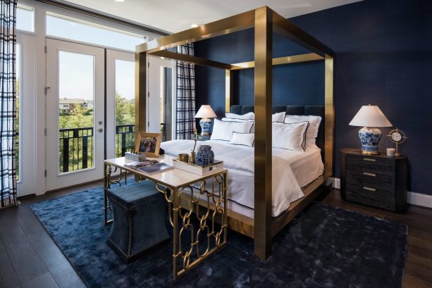 elegant bedroom with navy walls that match the rug and white french doors