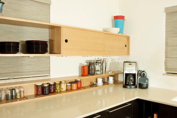 floating wall cabinet with a sliding door made of white oak