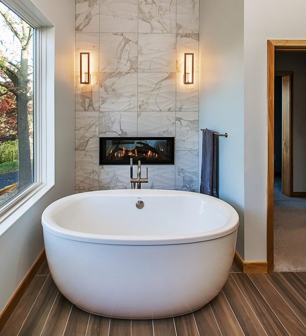 large tub facing a panoramic view in a man cave bathroom