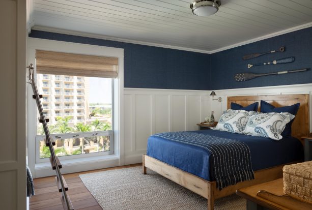 matching the bedsheet with the navy walls in a white panel bedroom