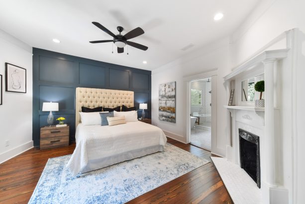 mid-sized bedroom with navy painted wainscoting in the middle of white walls