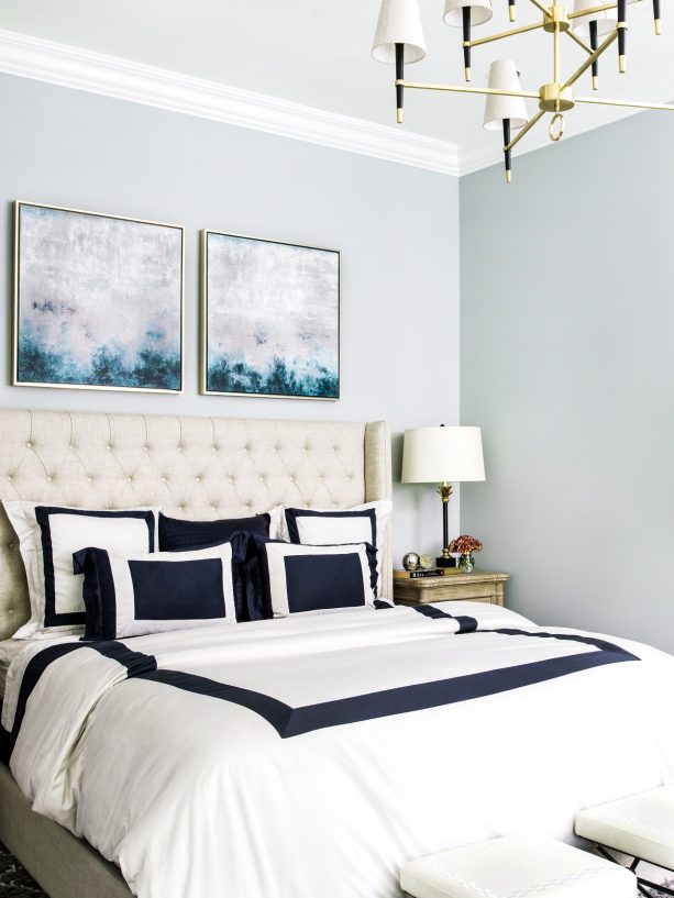 navy and white bedding in a soft grey bedroom