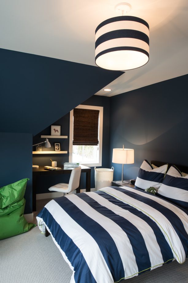 navy and white striped duvet that matches the round pendant in a transitional bedroom