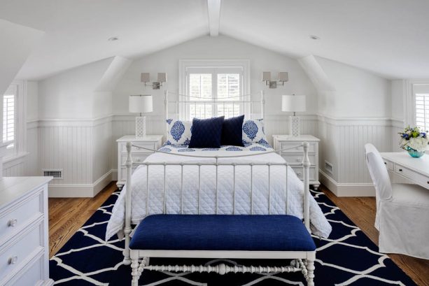 navy pillows and seat in a bright white bedroom