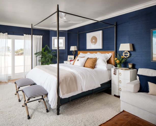 navy wallpaper in a white beach style bedroom