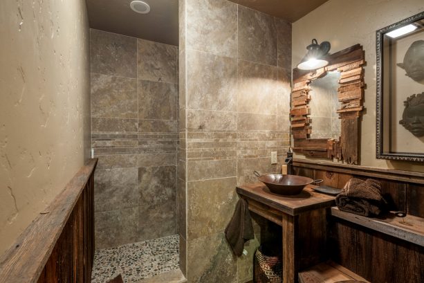 reclaimed barn wood in an african safari style man cave bathroom