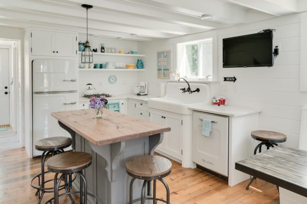 shabby chic beach style small kitchen in an l-shaped with a wood top island