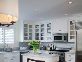small l-shaped kitchen layout in a traditional style with a white island