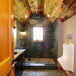 the combination of wood, stone, and tile in a man cave bathroom