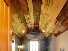 the combination of wood, stone, and tile in a man cave bathroom