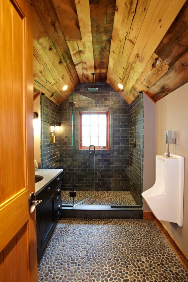 the combination of wood, stone, and tile in a man cave bathroom