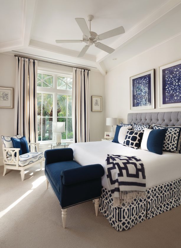 white luxurious bedroom with a navy accent