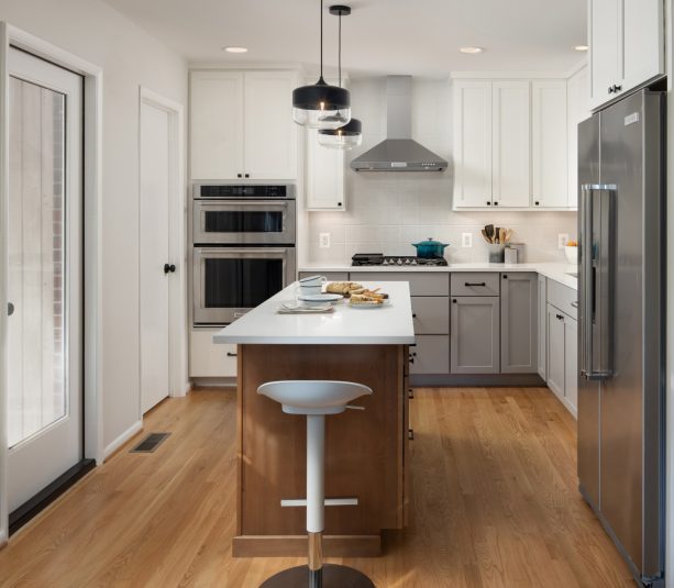 white mid-century small kitchen in an l-shaped with a long and narrow island