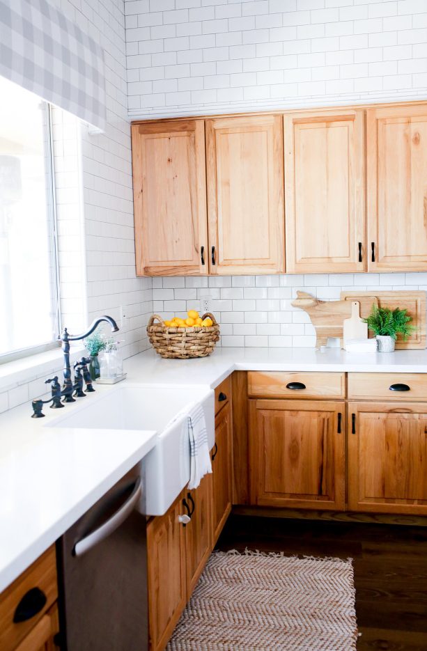 white quartz countertops with hickory oak cabinets in a farmhouse kitchen