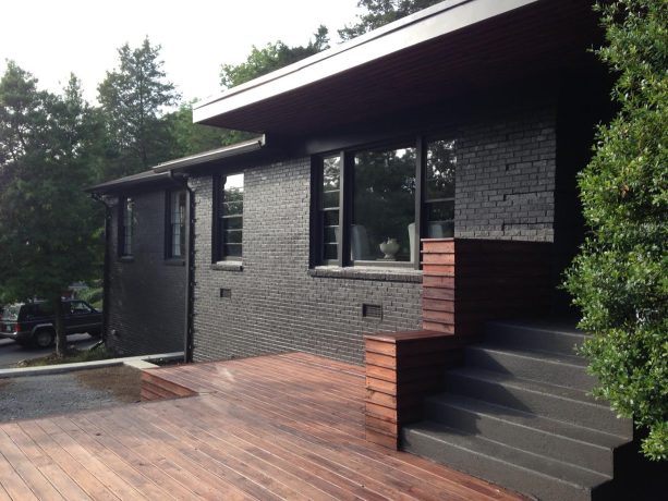 black painted brick combined with stained wood as a modern ranch house exterior