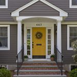 classic entryway with single recessed panel yellow front door