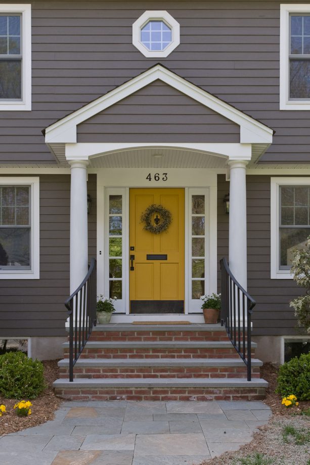 classic entryway with single recessed panel yellow front door
