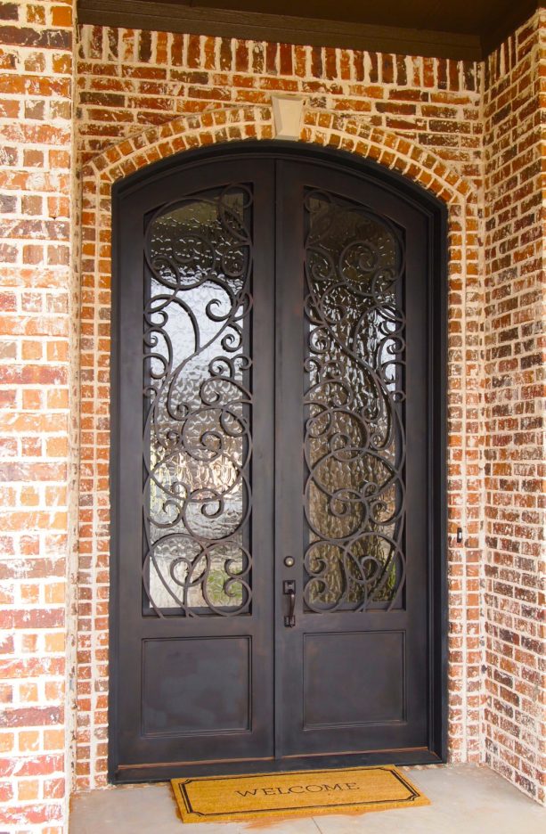 decorative brown front door made of wrought iron for a traditional entry