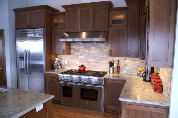 dentil molding in a brown shaker kitchen cabinetry as a trim