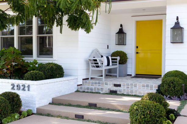 small yet elegant entryway with a minimalist yellow front door